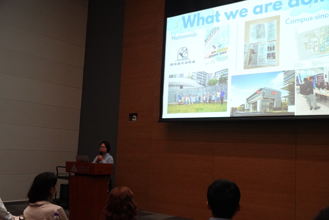 A person giving a presentation to a group of people

Description automatically generated