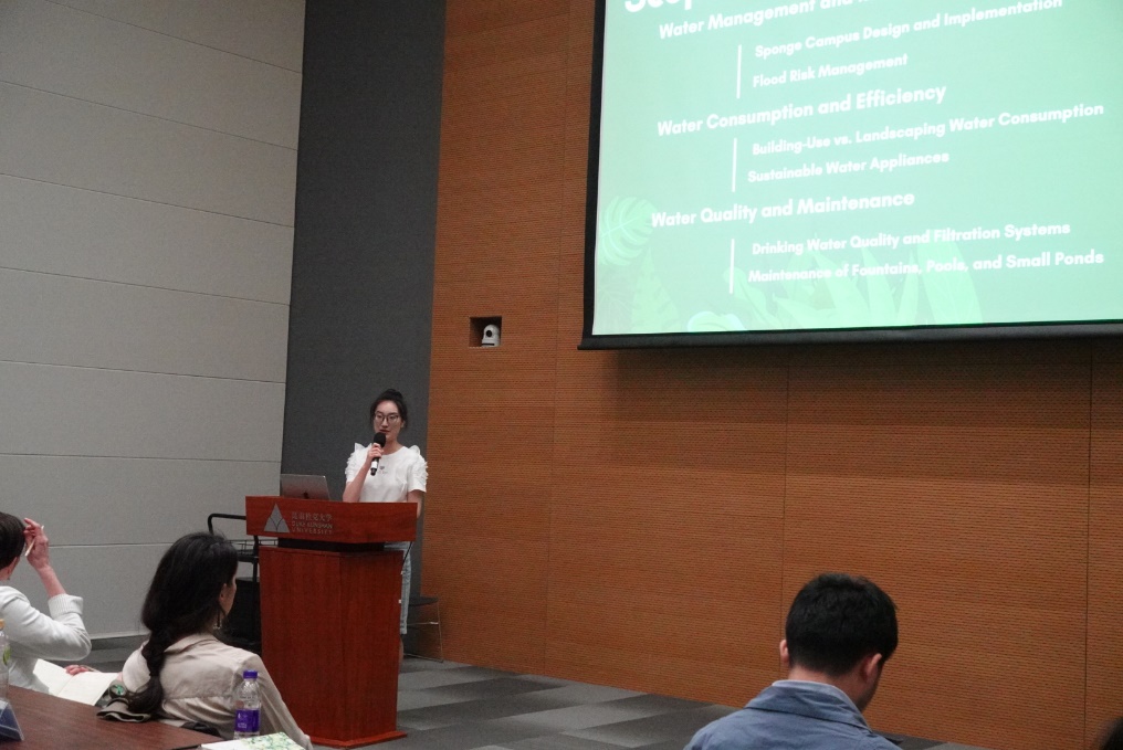 A person standing at a podium giving a presentation

Description automatically generated